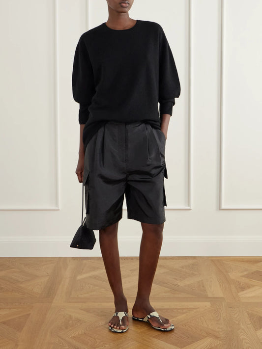Image of a model wearing Shorts. Product name - Stella Shell Shorts in Black colour by brand - Tibi
