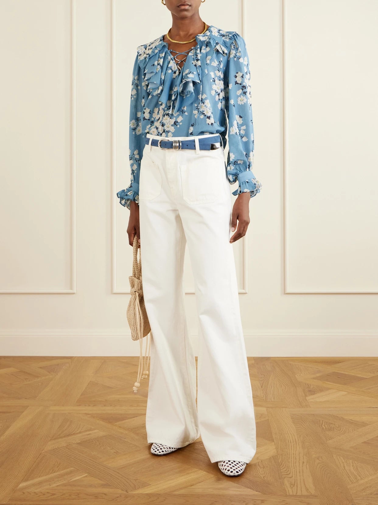 Image of a model wearing Tops. Product name - Milia Ruffled Floral-print Cotton-blend Voile Blouse in Blue colour by brand - RIXO
