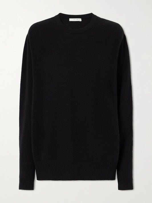 Image of a model wearing Outerwear. Product name - Odelle Cashmere Knit Sweater in Black colour by brand - The Row