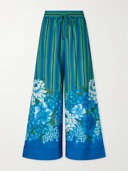 Image of a model wearing Pants. Product name - Margo Printed Organic Cotton-voile Wide-leg Pants in Multi colour by brand - ALÉMAIS