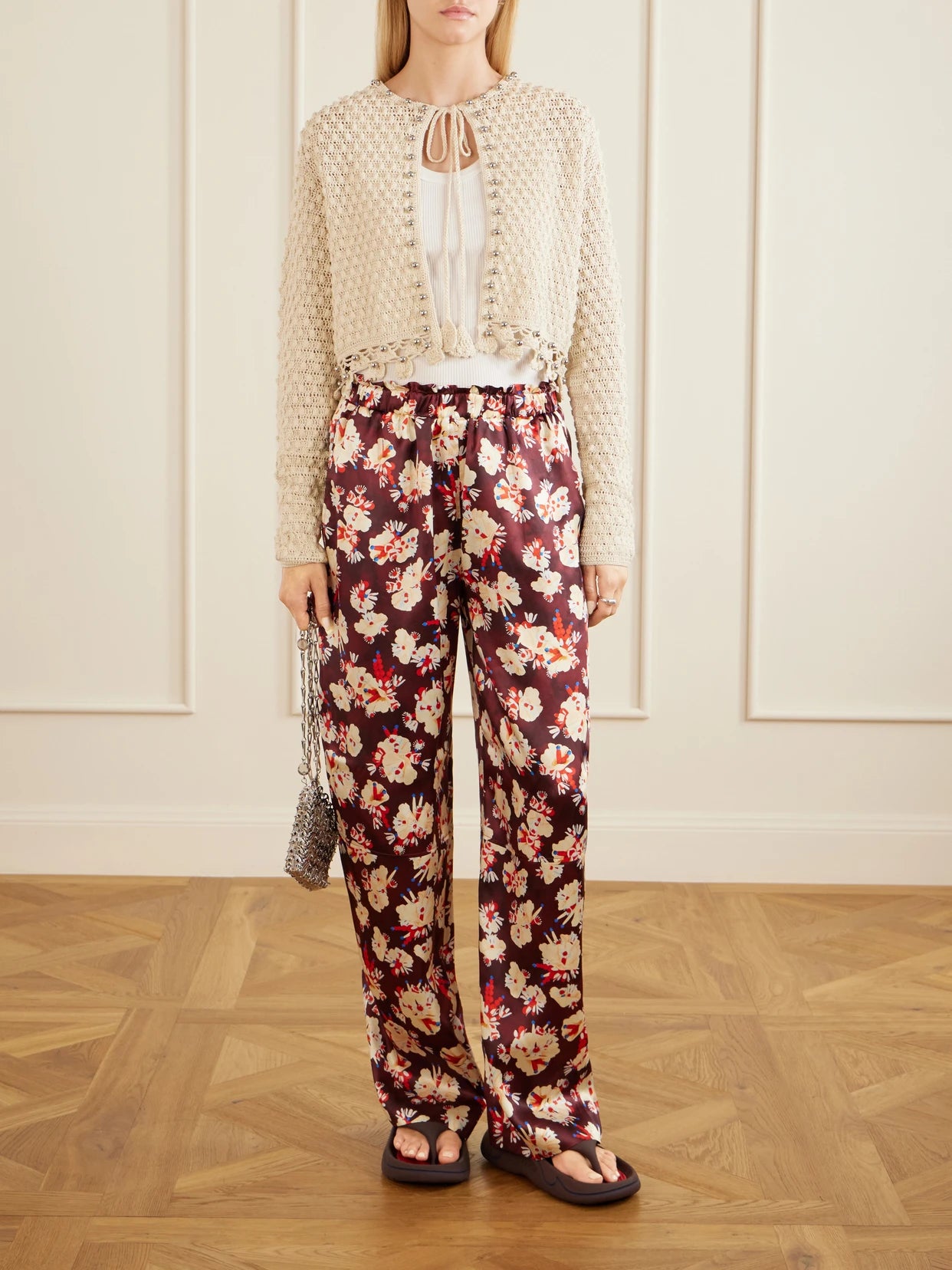 Image of a model wearing Outerwear. Product name - Embellished Crocheted Cotton Cardigan in Ecru colour by brand - RABANNE