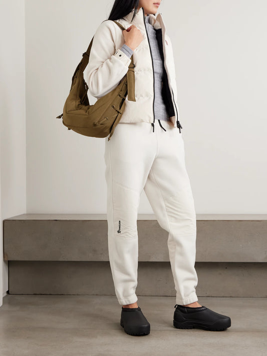 Image of a model wearing Outerwear. Product name - Shell-paneled Fleece Tapered Sweatpants in White colour by brand - Moncler Grenoble