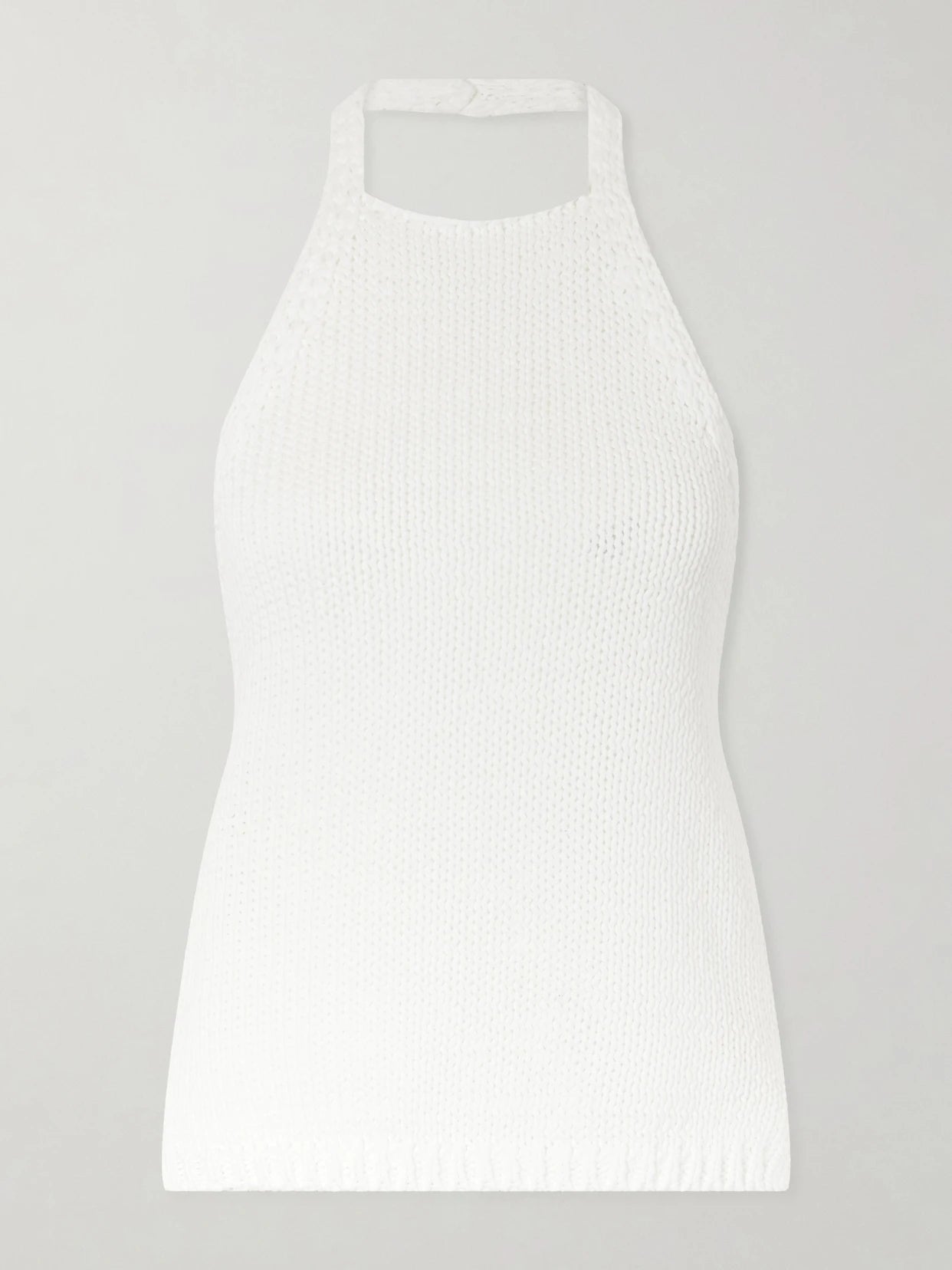 Image of a model wearing Tops. Product name - Knitted Cotton Halterneck Top in White colour by brand - RÓHE
