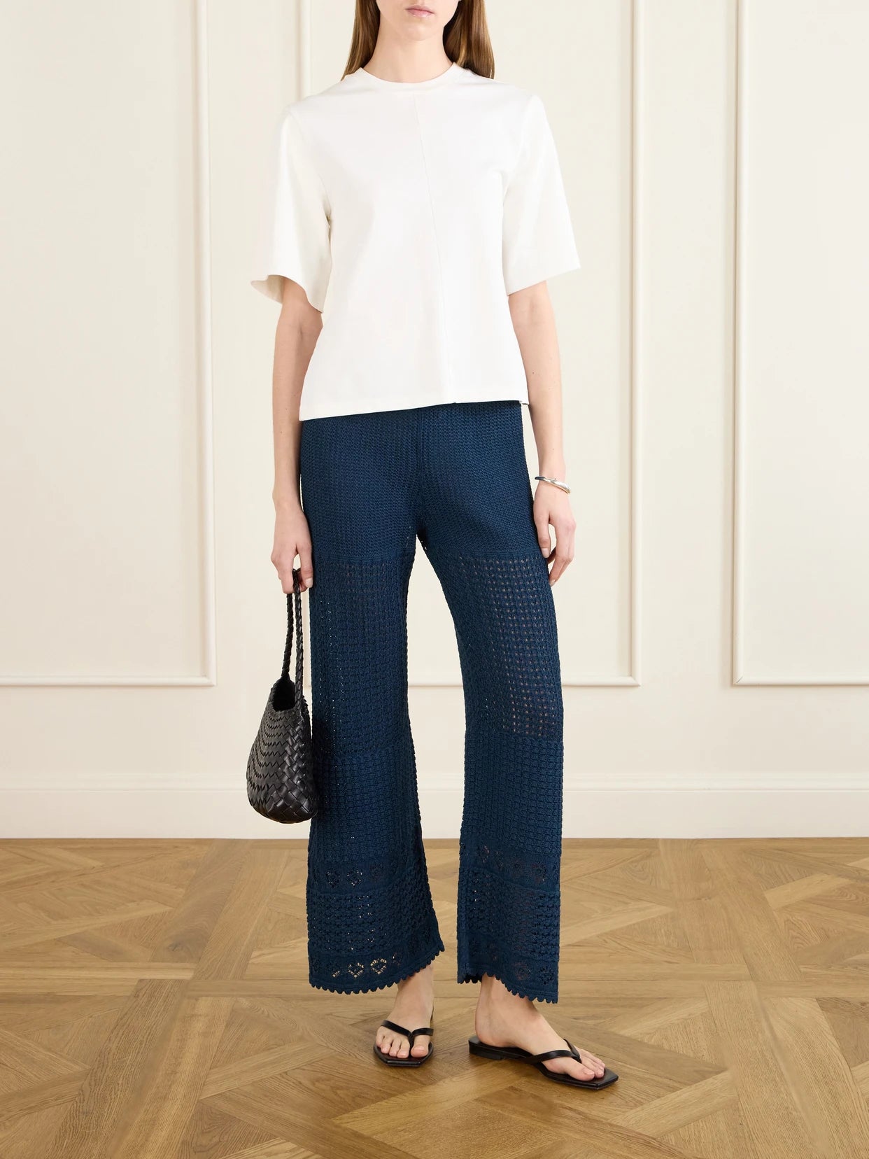 Image of a model wearing Pants. Product name - Emblème Crocheted Cotton-blend Straight-leg Pants in Navy colour by brand - Eres