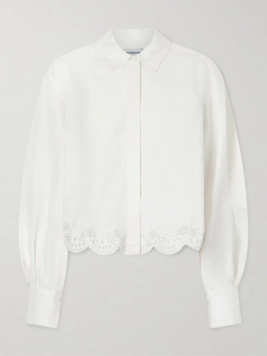 Image of a model wearing Tops. Product name - Ames Cropped Broderie Anglaise Linen-blend Shirt in White colour by brand - SIMKHAI