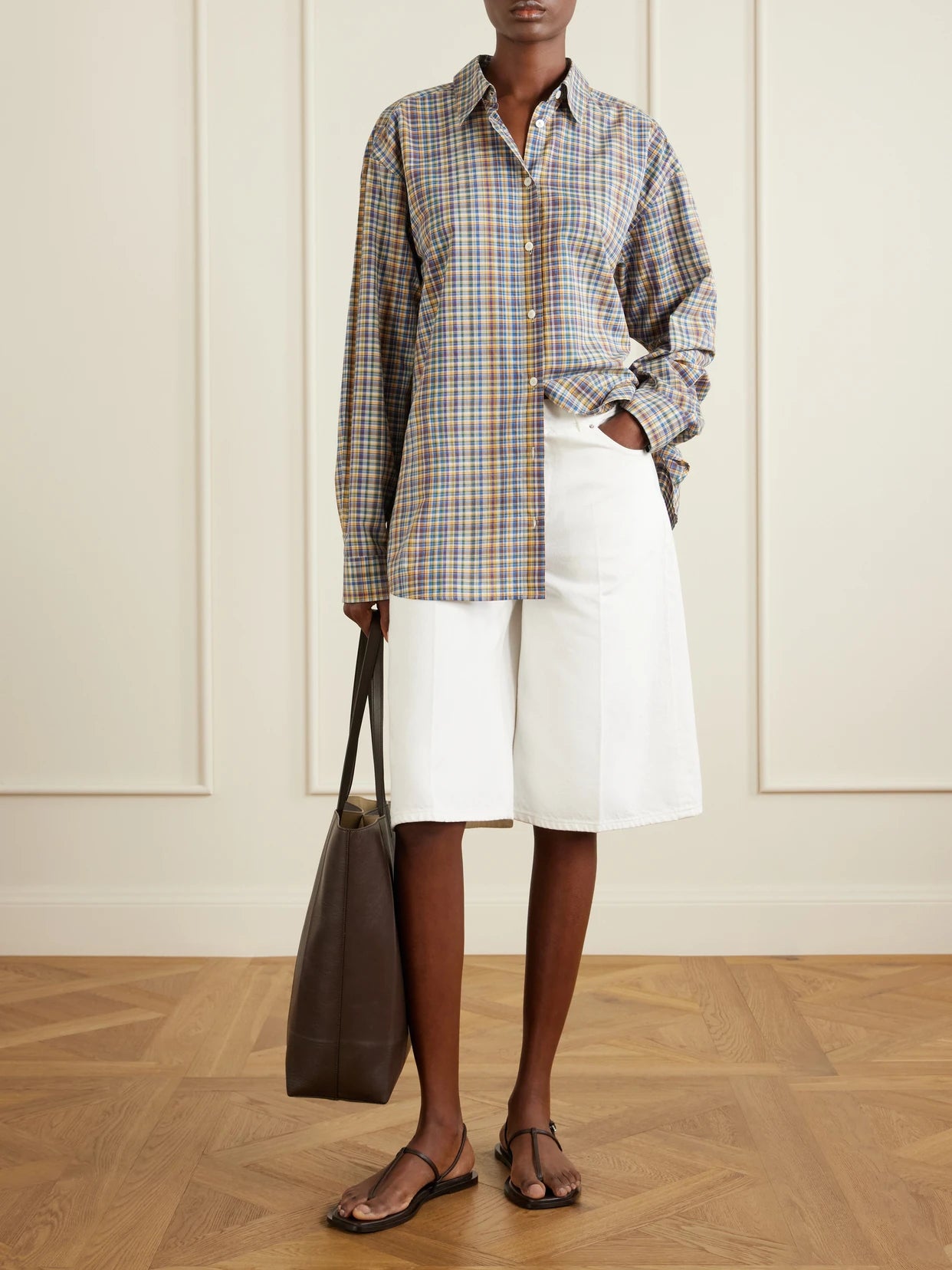 Image of a model wearing Shorts. Product name - Denim Wide-leg Shorts in White colour by brand - TOTEME
