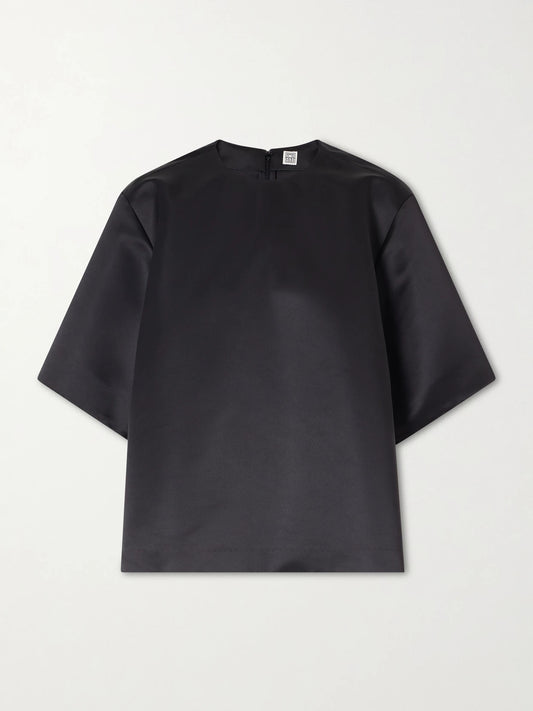 Image of a model wearing Tops. Product name - Duchesse-satin Blouse in Black colour by brand - TOTEME
