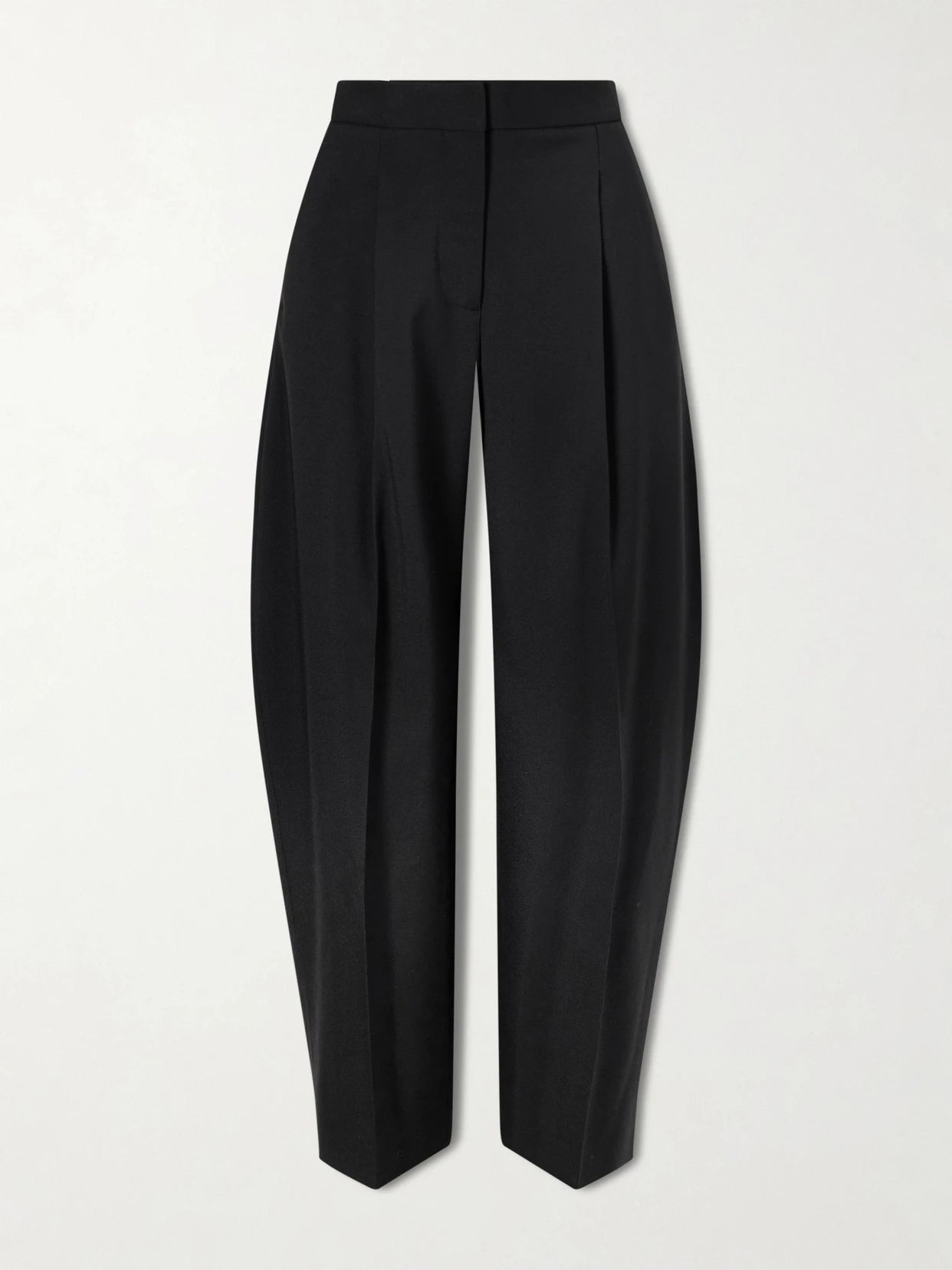 Image of a model wearing Pants. Product name - Pleated Wool-blend Gabardine Tapered Pants in Black colour by brand - Alaïa