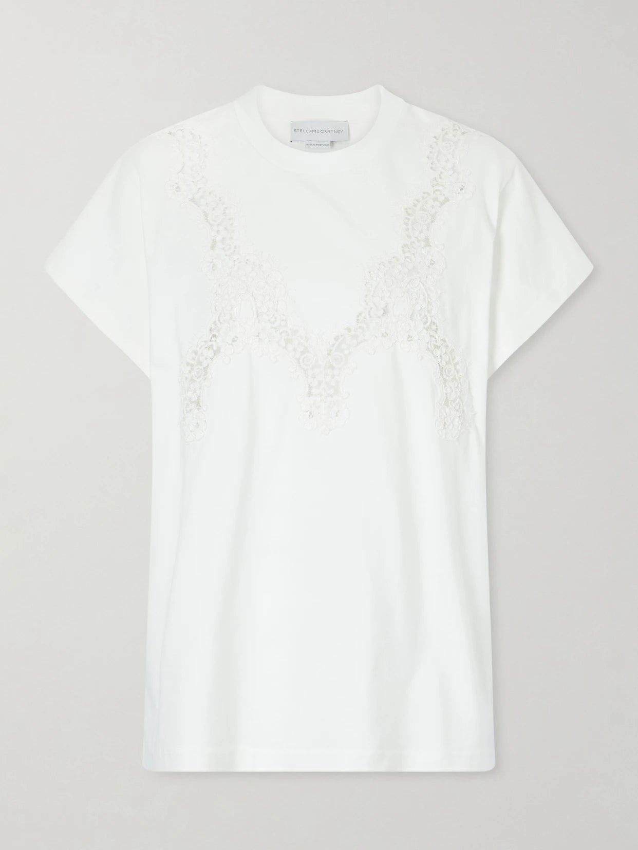 Image of a model wearing Tops. Product name - Lace-trimmed Cotton-jersey T-shirt in White colour by brand - Stella McCartney