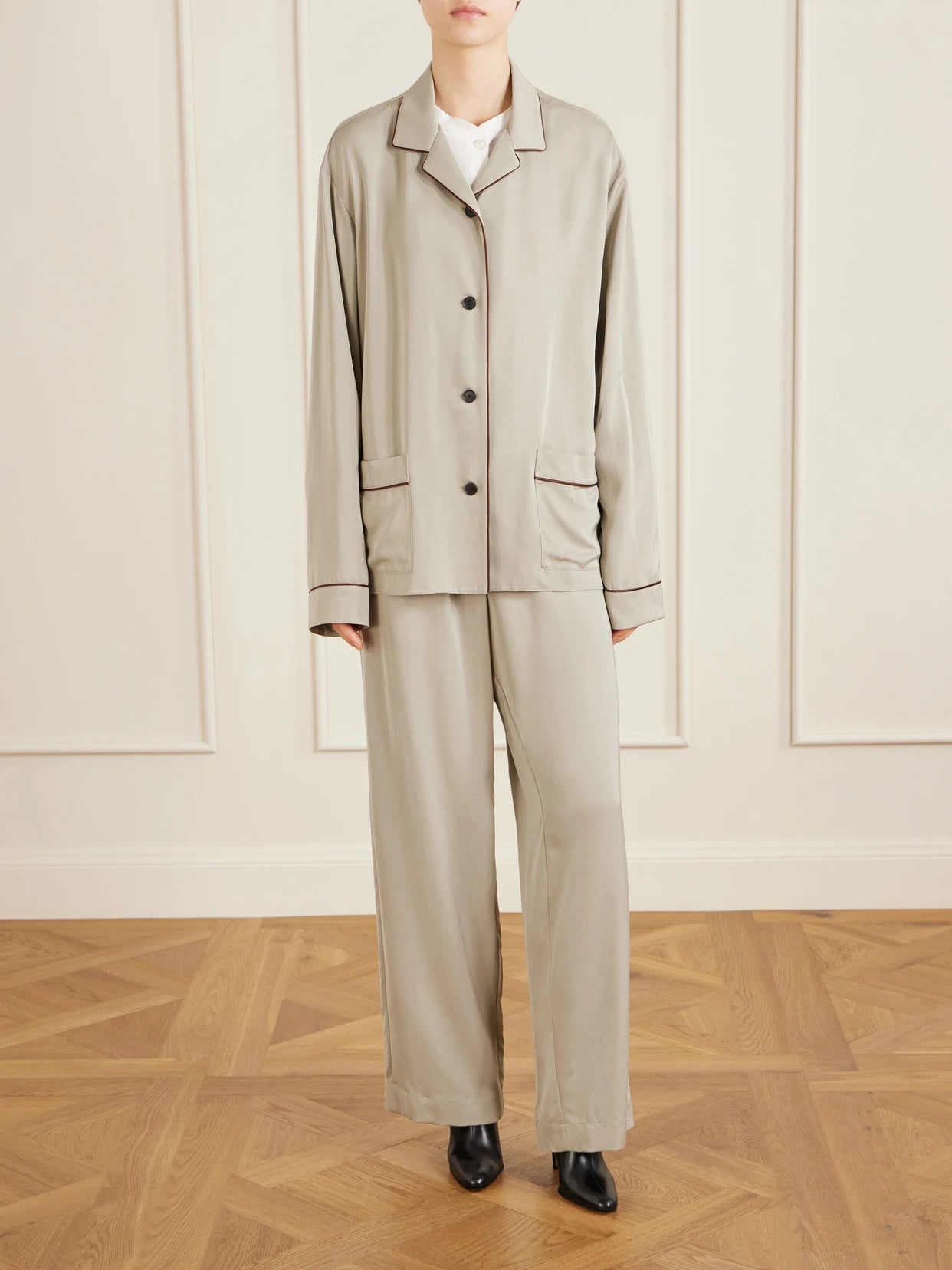 Image of a model wearing Pants. Product name - Duvain Silk Straight-leg Pants in Cream colour by brand - The Row