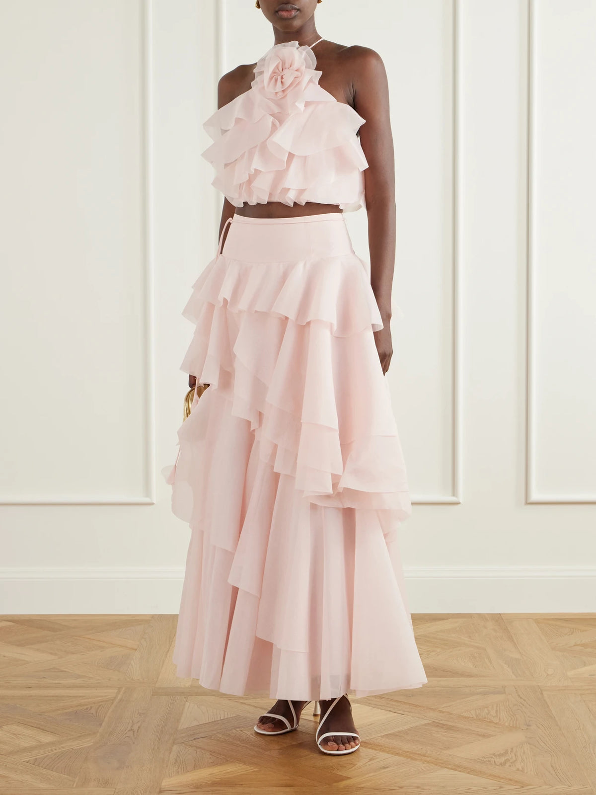 Image of a model wearing Skirts. Product name - Villa Ruffled Organza Midi Skirt in Baby pink colour by brand - Aje