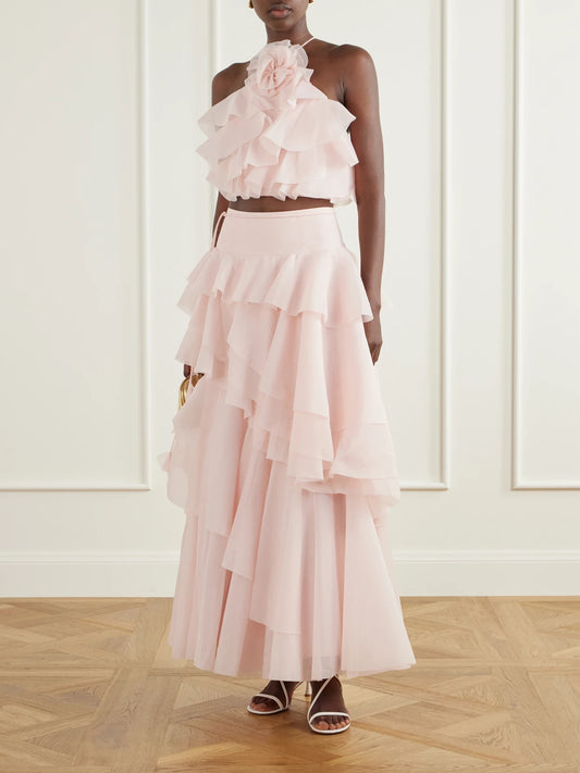 Image of a model wearing Skirts. Product name - Villa Ruffled Organza Midi Skirt in Baby pink colour by brand - Aje