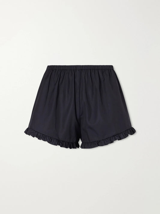 Image of a model wearing Shorts. Product name - Ruffled Cotton-poplin Shorts in Black colour by brand - Hunza G