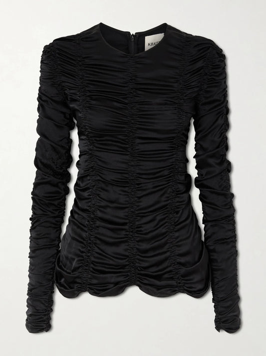 Image of a model wearing Tops. Product name - Rory Ruched Silk-satin Top in Black colour by brand - KHAITE