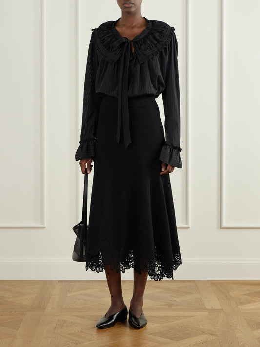 Image of a model wearing Tops. Product name - Dauphine Ruffled Striped Cotton-voile Blouse in Black colour by brand - Thierry Colson