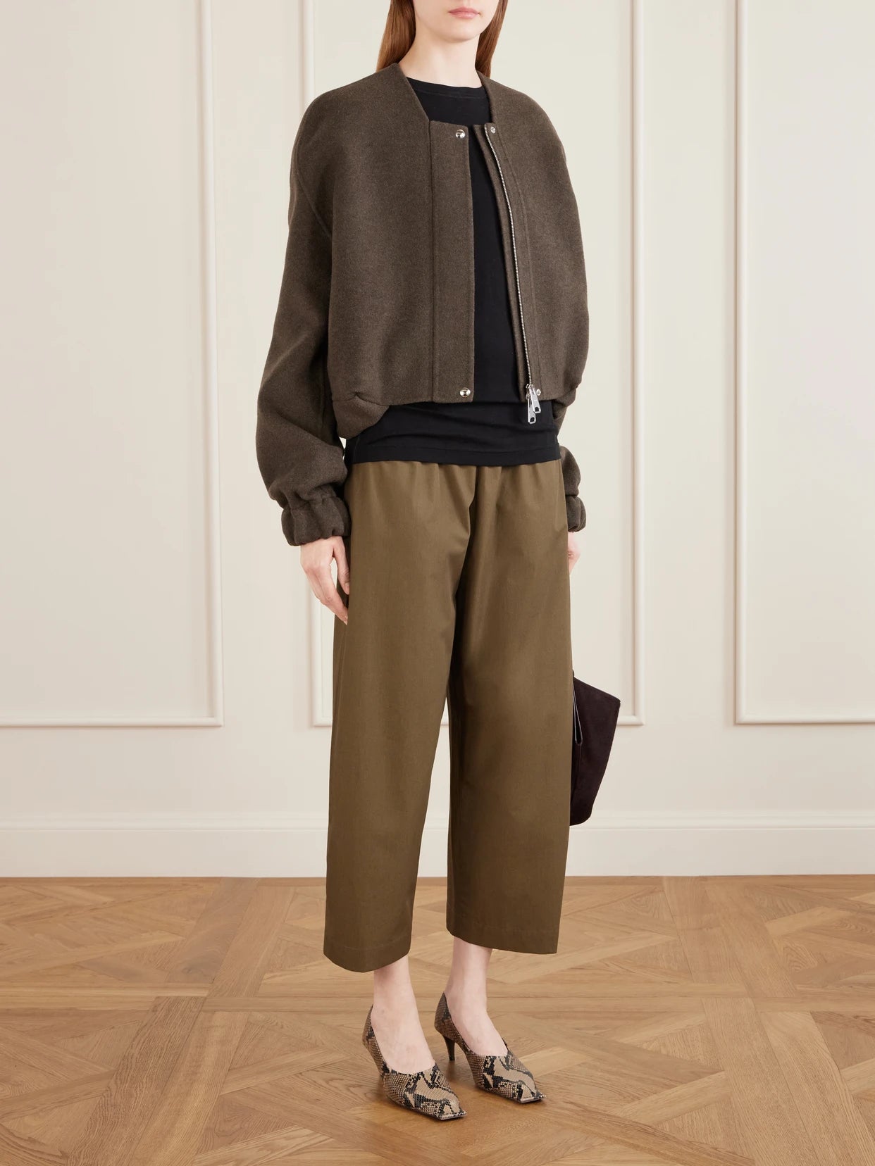 Image of a model wearing Pants. Product name - Roma Cotton-poplin Wide-leg Pants in Army green colour by brand - KHAITE