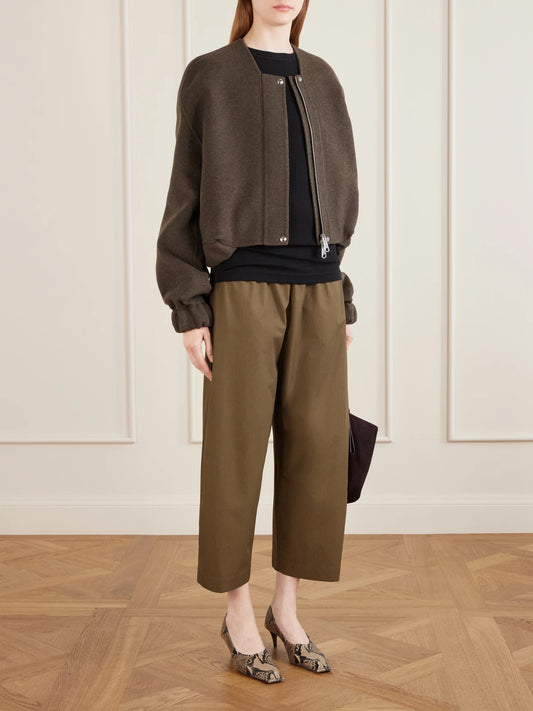 Image of a model wearing Pants. Product name - Roma Cotton-poplin Wide-leg Pants in Army green colour by brand - KHAITE