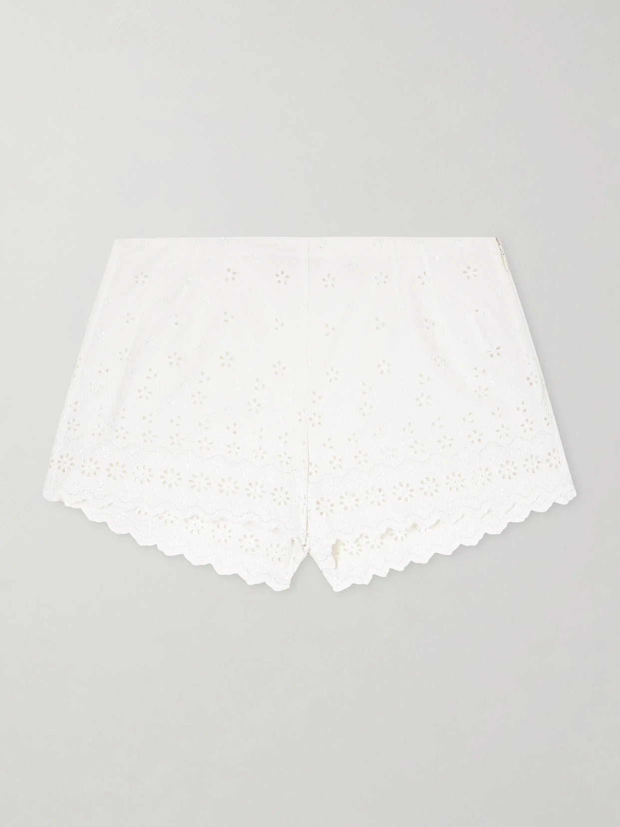 Image of a model wearing Shorts. Product name - Arda Broderie Anglaise Organic Cotton Shorts in White colour by brand - DÔEN