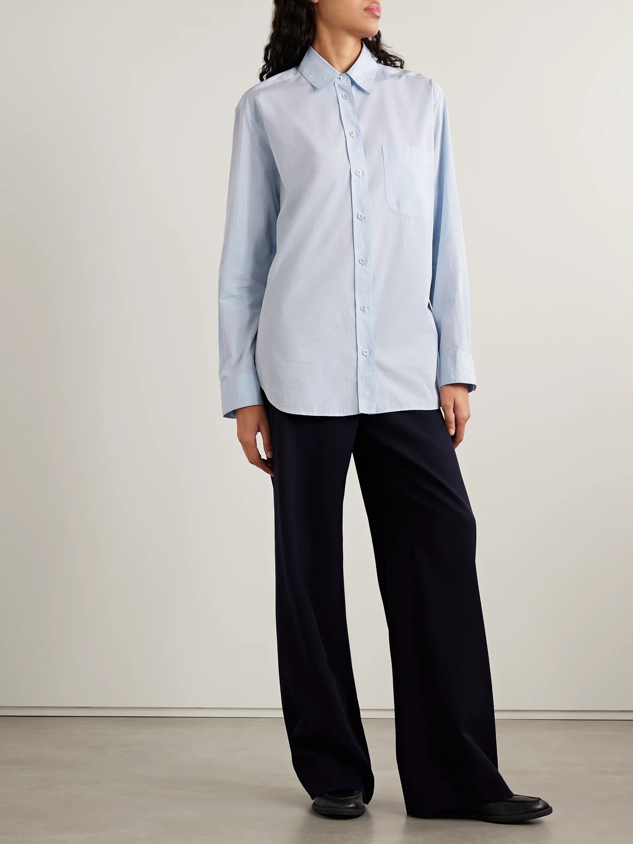 Image of a model wearing Tops. Product name - Gavina Sea Island Cotton Shirt in Light blue colour by brand - The Row