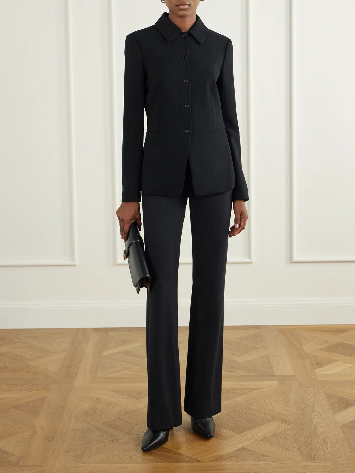 Image of a model wearing Pants. Product name - Gracie Stretch-jersey Flared Pants in Black colour by brand - Veronica Beard