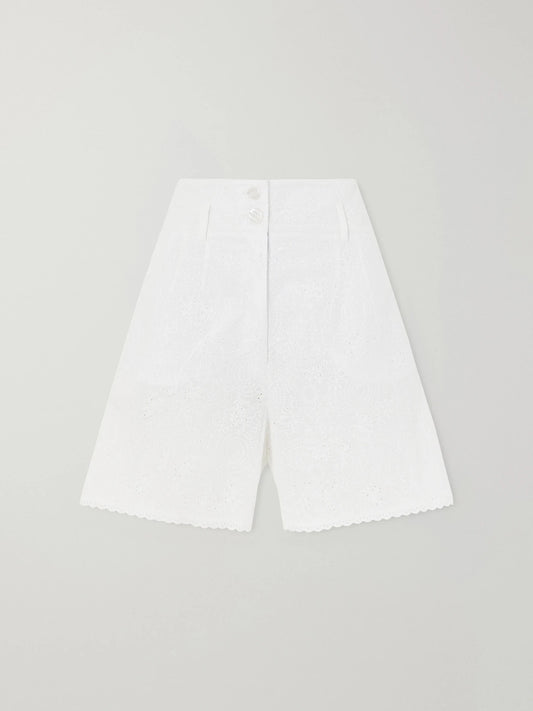 Image of a model wearing Shorts. Product name - Rocchetta Scalloped Broderie Anglaise Cotton Shorts in White colour by brand - Loretta Caponi