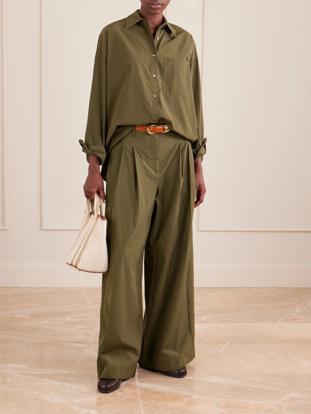 Image of a model wearing Pants. Product name - New Didi Cotton Wide-leg Pants in Army green colour by brand - TWP