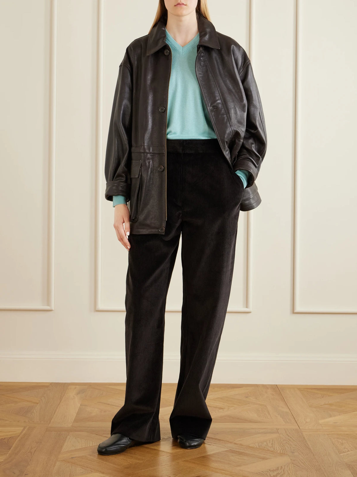 Image of a model wearing Pants. Product name - Grange Cotton-corduroy Wide-leg Pants in Dark brown colour by brand - Studio Nicholson