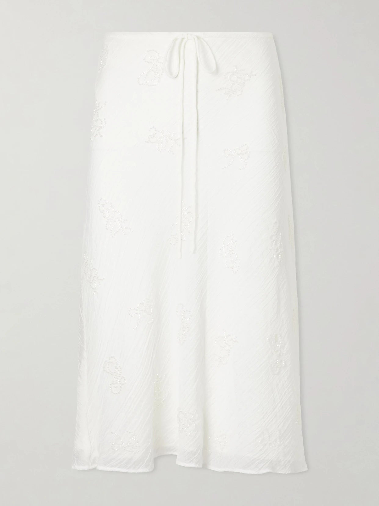 Image of a model wearing Skirts. Product name - Lucia Bead-embellished Crinkled Modal-blend Organza Midi Skirt in White colour by brand - STAUD