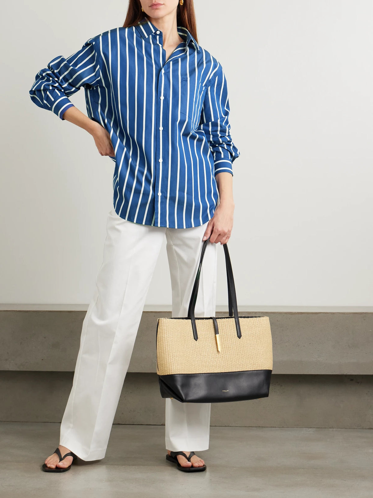 Image of a model wearing Tops. Product name - Striped Cotton-poplin Shirt in Blue colour by brand - Matteau