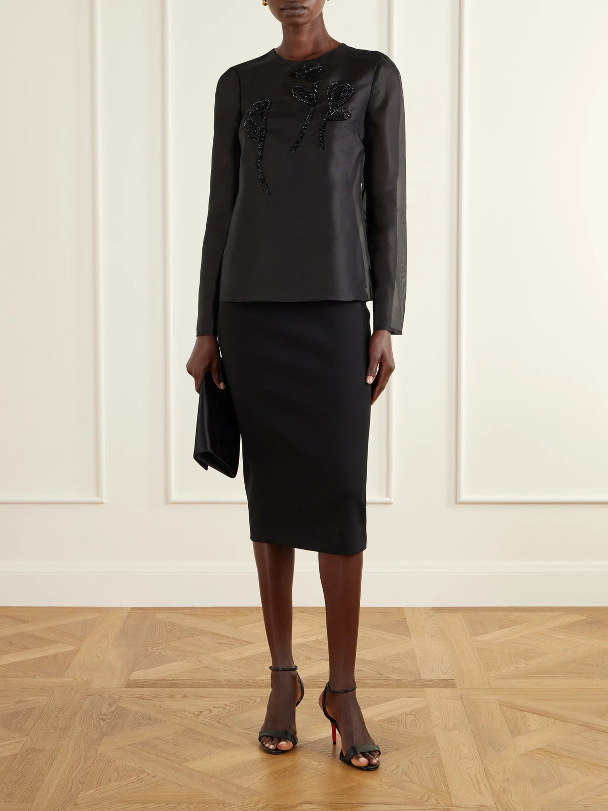 Image of a model wearing Tops. Product name - Sequin-embellished Embroidered Silk-organza Blouse in Black colour by brand - Carolina Herrera