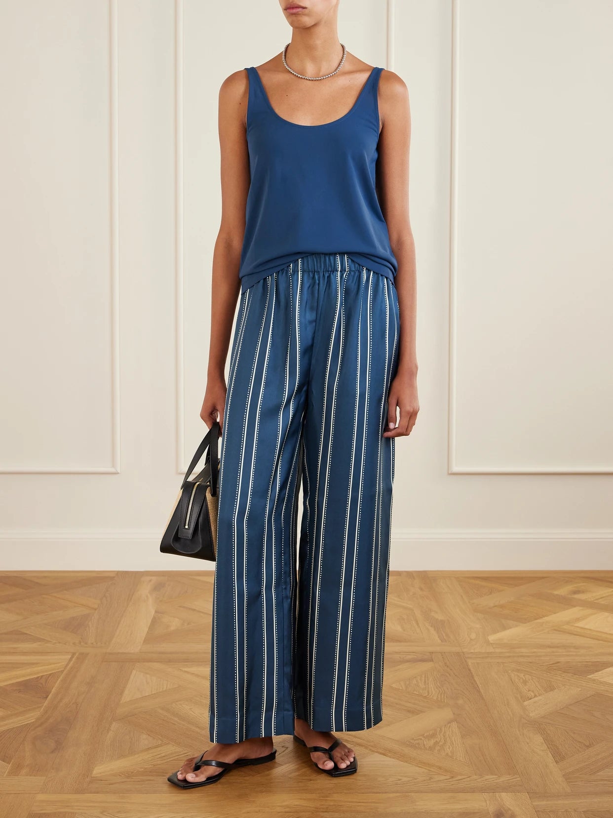 Image of a model wearing Tops. Product name - Anae Stretch-jersey Tank in Navy colour by brand - Eres