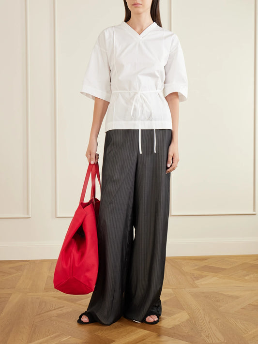 Image of a model wearing Pants. Product name - Cairo Striped Silk And Cotton-poplin Wide-leg Pants in Black colour by brand - KALLMEYER