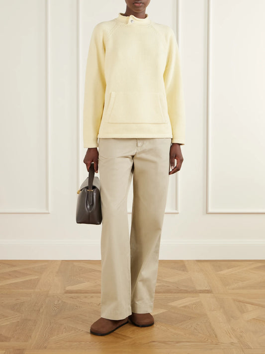 Image of a model wearing Outerwear. Product name - Snap Collar Cotton Sweater in Pastel yellow colour by brand - Still Here