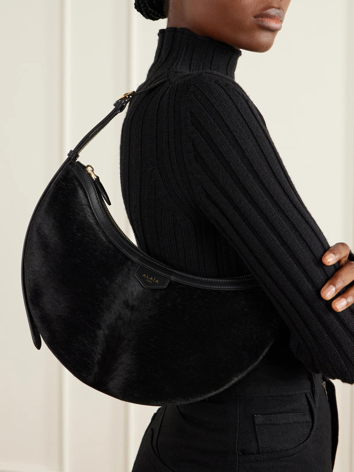 Image of Bags. Product name - Demi Lune Leather-trimmed Calf-hair Shoulder Bag in Black colour by brand - Alaïa
