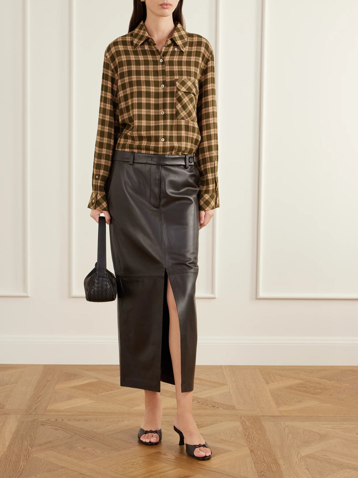 Image of a model wearing Skirts. Product name - Double-slit Leather Midi Skirt in Brown colour by brand - Co