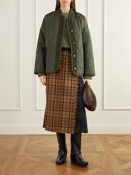Image of a model wearing Skirts. Product name - Hazelwood Two-tone Pleated Checked Flannel Midi Skirt in Brown colour by brand - Barbour
