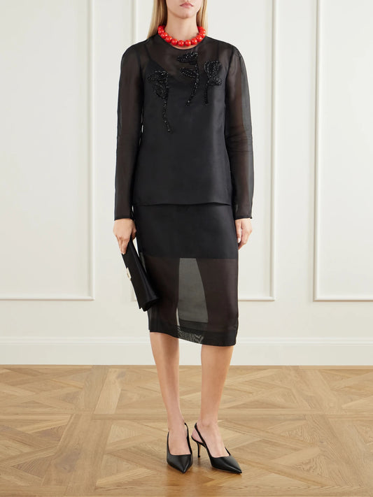 Image of a model wearing Skirts. Product name - Silk-organza Midi Skirt in Black colour by brand - Carolina Herrera