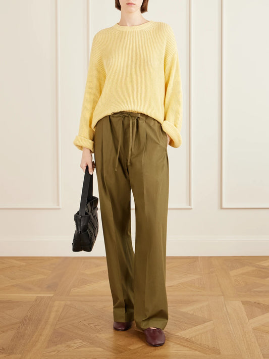 Image of a model wearing Pants. Product name - Pleated Cotton-poplin Straight-leg Pants in Army green colour by brand - Another Tomorrow