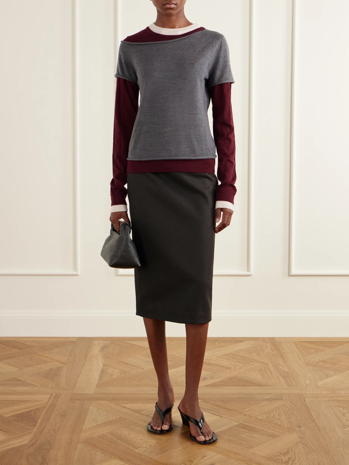 Image of a model wearing Outerwear. Product name - Sera Layered Wool-blend Sweater in Gray colour by brand - STAUD