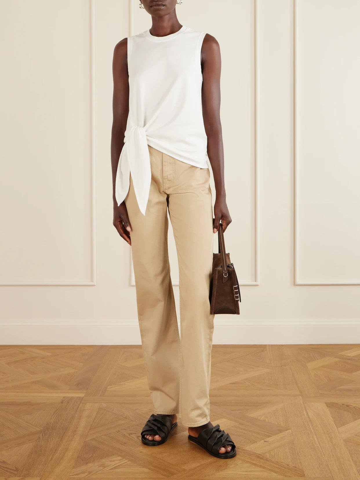 Image of a model wearing Tops. Product name - Knotted Logo-embroidered Cotton-jersey Tank in White colour by brand - JW Anderson