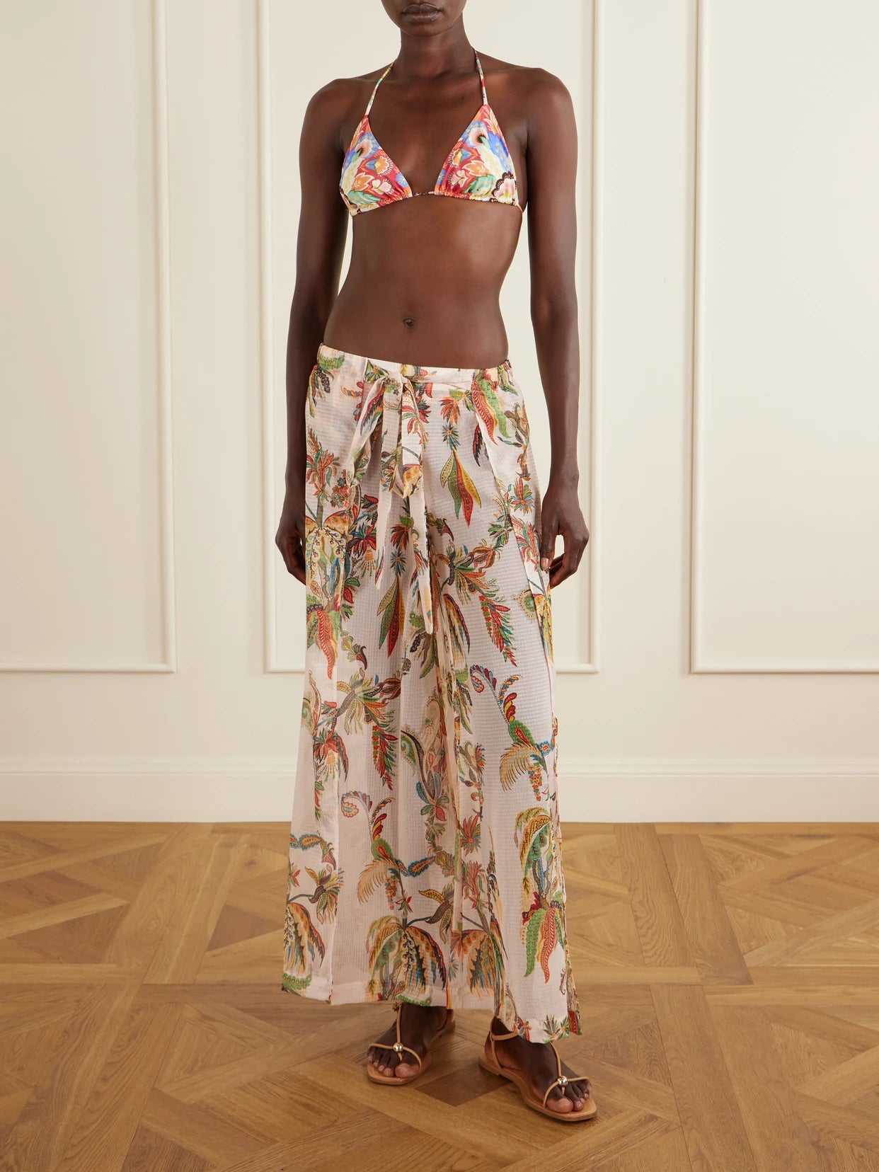Image of a model wearing Pants. Product name - Belted Tiered Paisley And Floral-print Satin Wide-leg Pants in Pink colour by brand - Etro