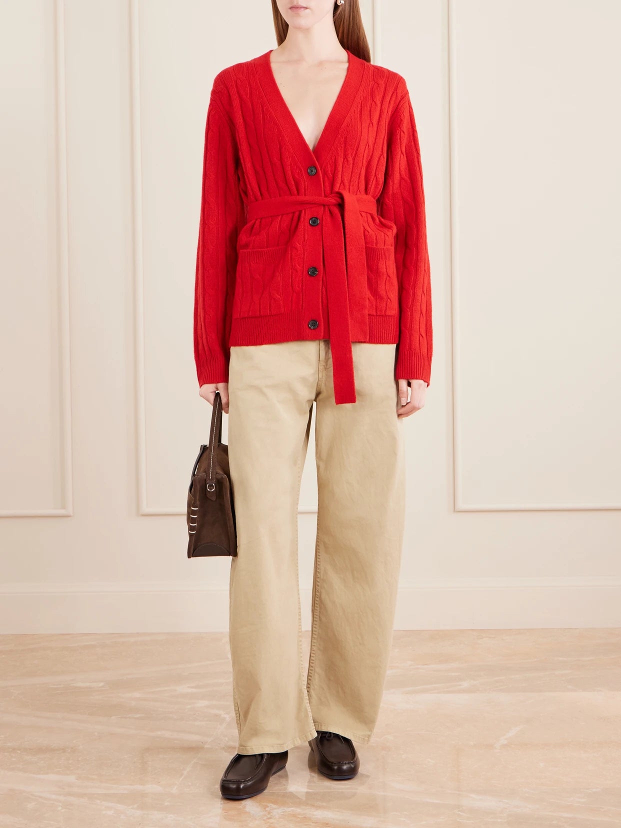 Image of a model wearing Outerwear. Product name - Tirza Belted Cable-knit Cashmere Cardigan in Red colour by brand - Nili Lotan