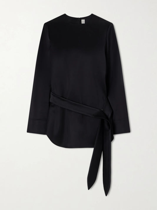 Image of a model wearing Tops. Product name - Belted Satin Blouse in Black colour by brand - TOTEME