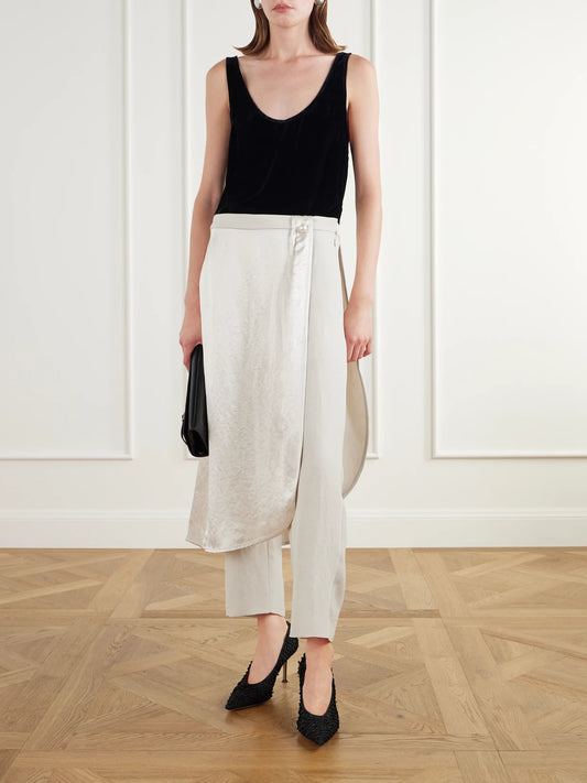 Image of a model wearing Pants. Product name - Layered Wrap-effect Satin Straight-leg Pants in Ivory colour by brand - Maria McManus