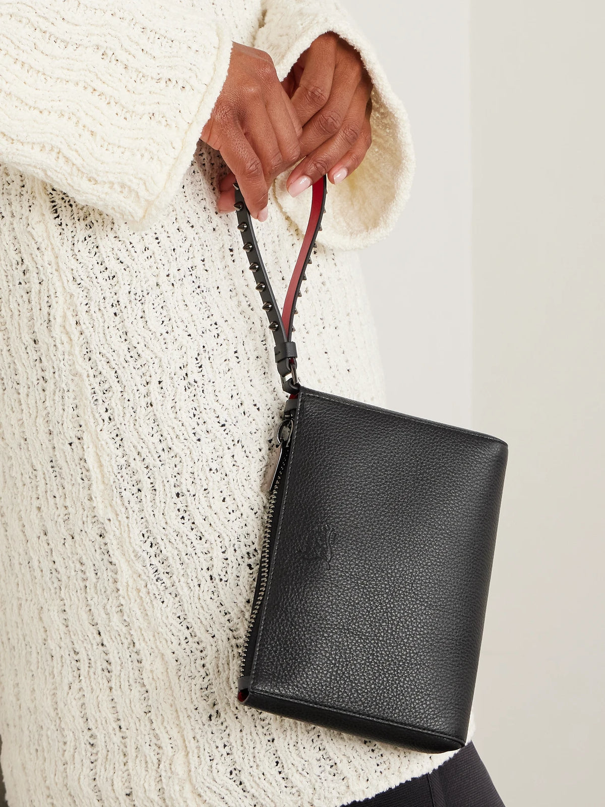 Image of Bags. Product name - Cabata Studded Textured-leather Clutch in Black colour by brand - Christian Louboutin