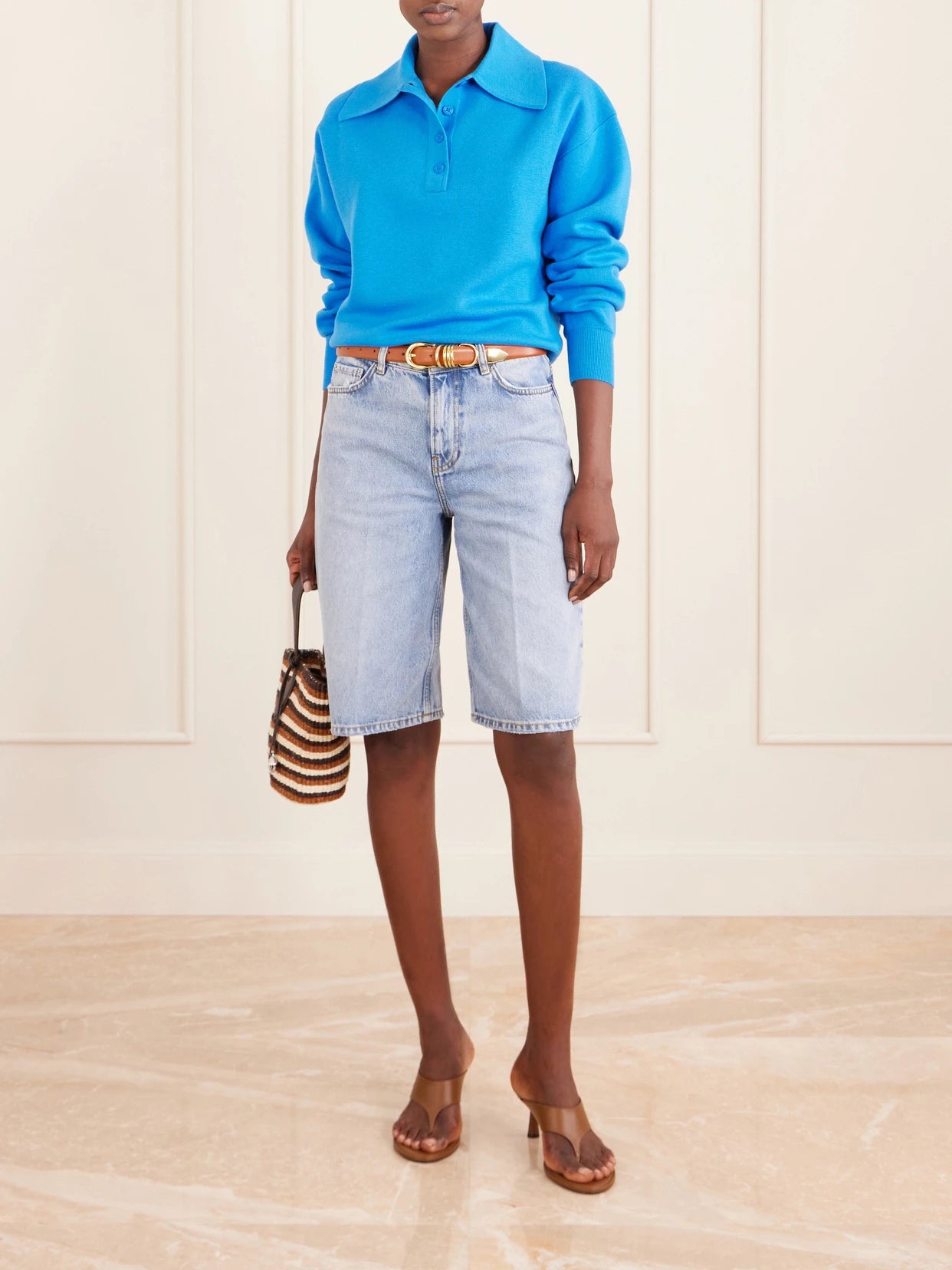 Image of a model wearing Outerwear. Product name - Claudia Knitted Wool Polo Shirt in Blue colour by brand - ALÉMAIS