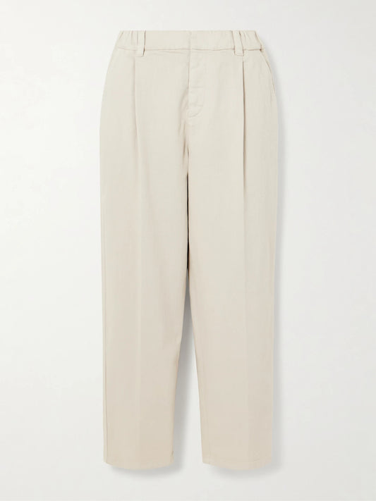 Image of a model wearing Pants. Product name - Cropped Pleated Stretch-cotton Twill Tapered Pants in White colour by brand - Brunello Cucinelli