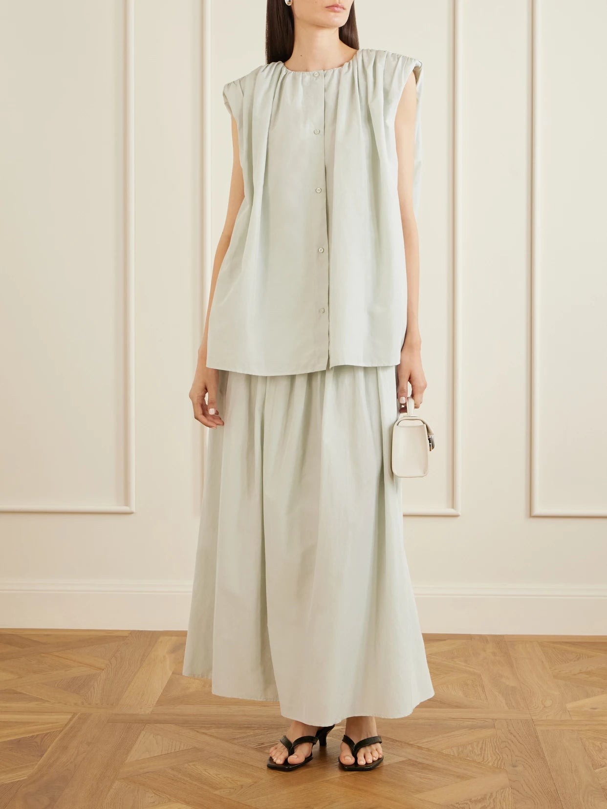 Image of a model wearing Skirts. Product name - Naya Gathered Cotton And Silk-blend Maxi Skirt in Light green colour by brand - Loulou de Saison