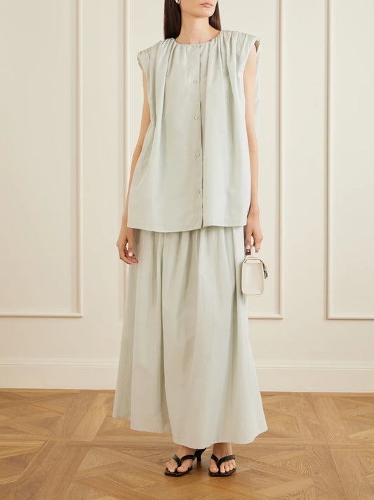 Image of a model wearing Skirts. Product name - Naya Gathered Cotton And Silk-blend Maxi Skirt in Light green colour by brand - Loulou de Saison