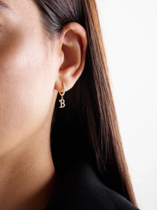 Image of Earrings. Product name - Initial Huggie 18-karat Gold Diamond Single Earring in A colour by brand - Anita Ko